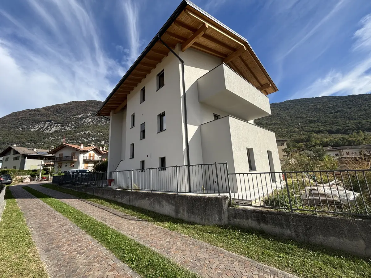 Palazzina ristrutturata con tetto in legno e intonaco bianco